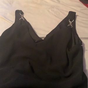 It’s black and has sliver chained tank top look on the top. It’s a 12 and flowy.